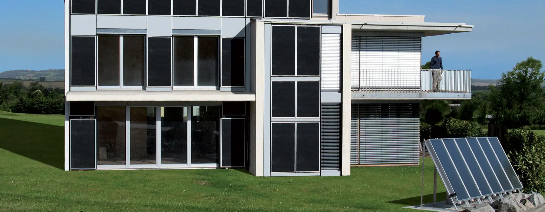Modern house with solar collectors in the garden